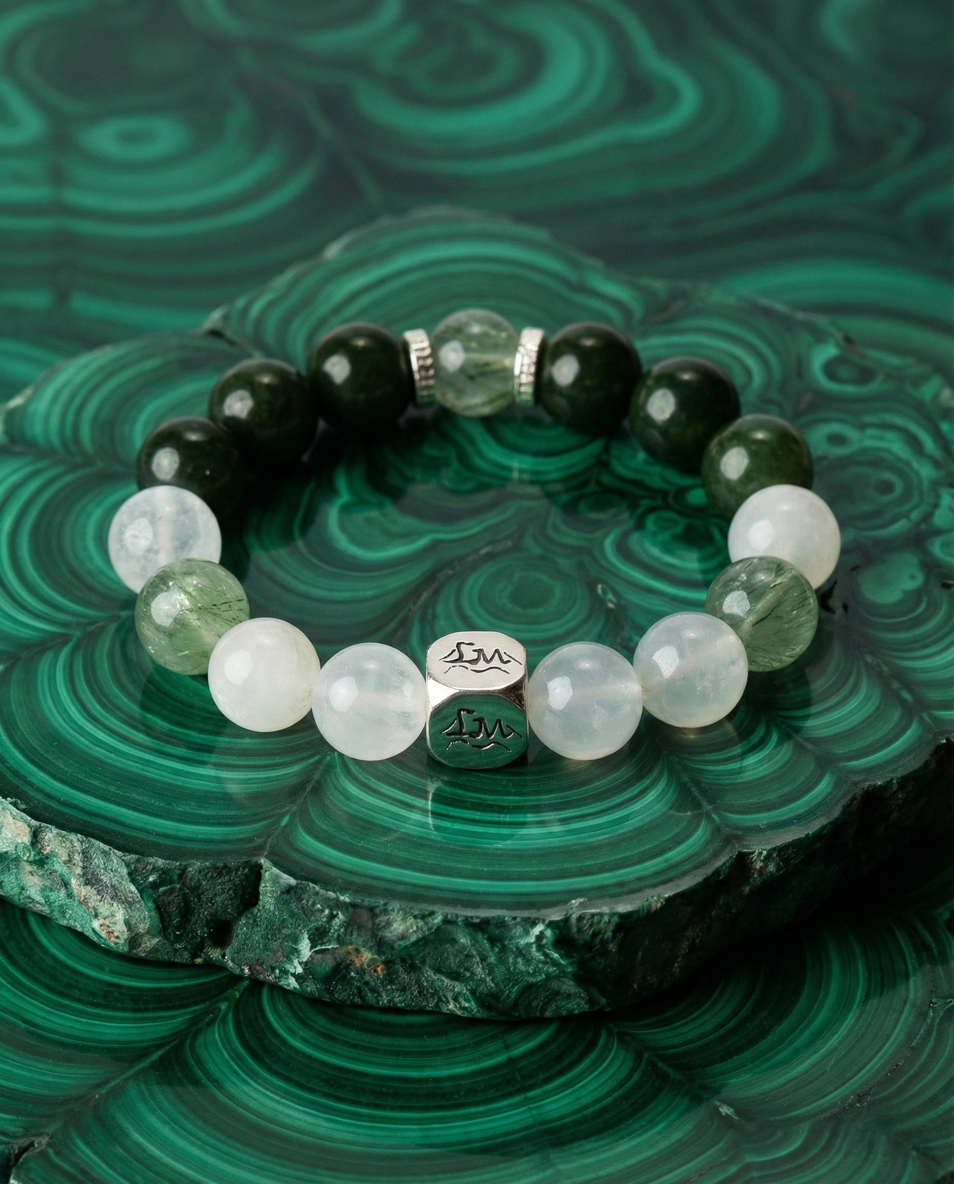 Astra wood crystal bracelet — nephrite jade snow quartz and green rutilated quartz — on malachite mineral slab — Leymen Jewels