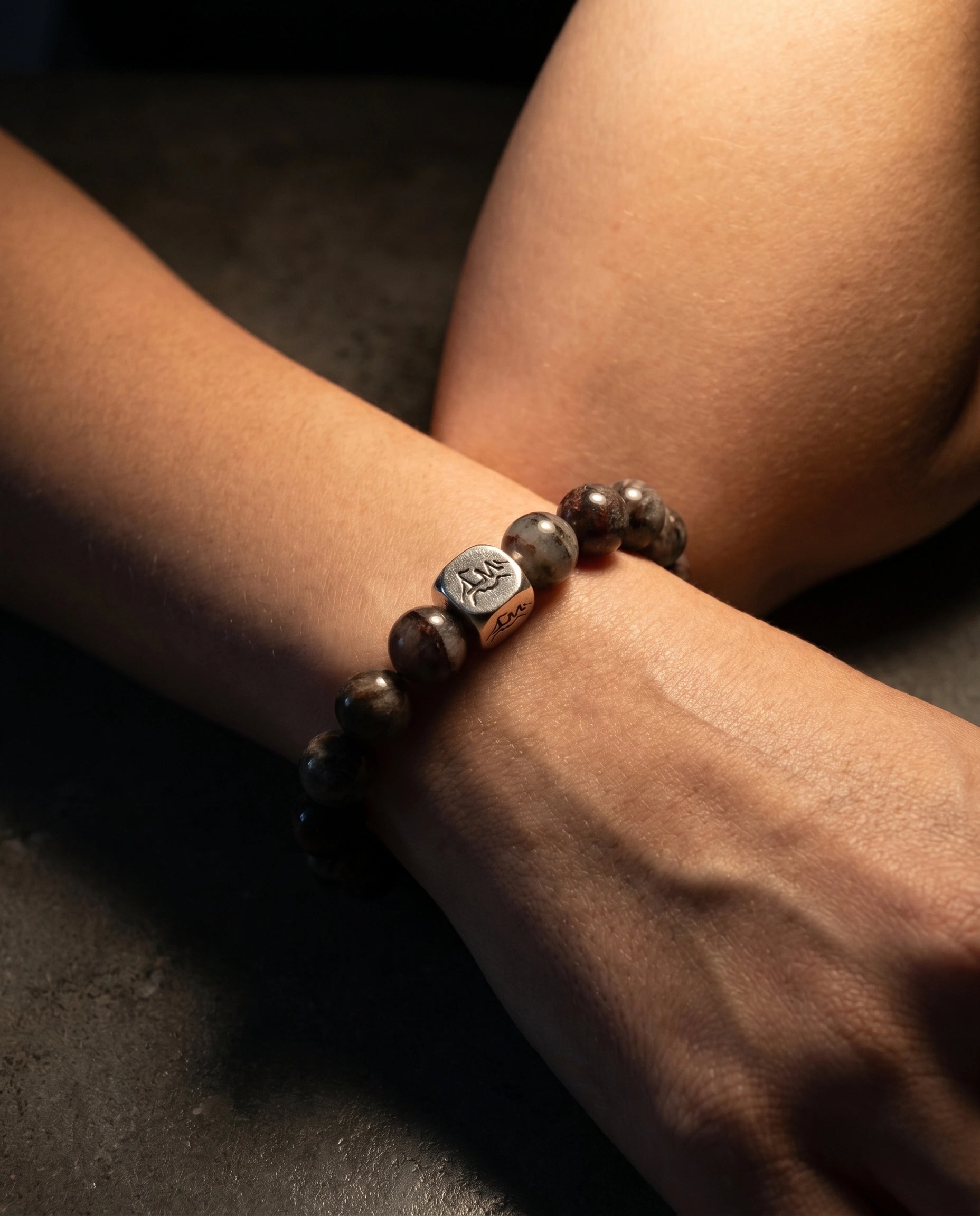 Axis metal crystal bracelet — cintamani macro detail showing engraved star medallion and black auralite-23 — Leymen Jewels