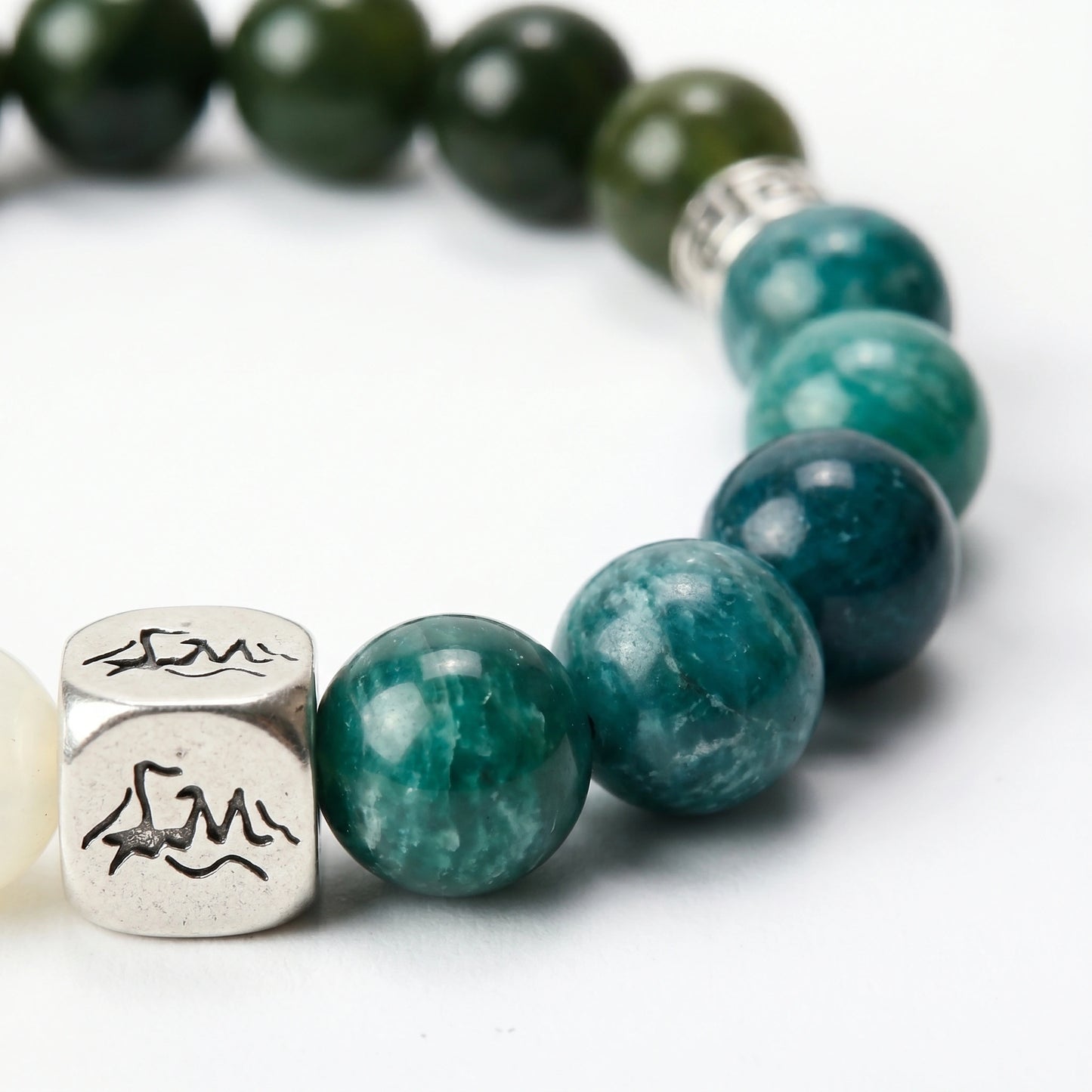 Canopy wood crystal bracelet — teal kyanite macro detail showing deep teal beads with white cloud patterning — Leymen Jewels