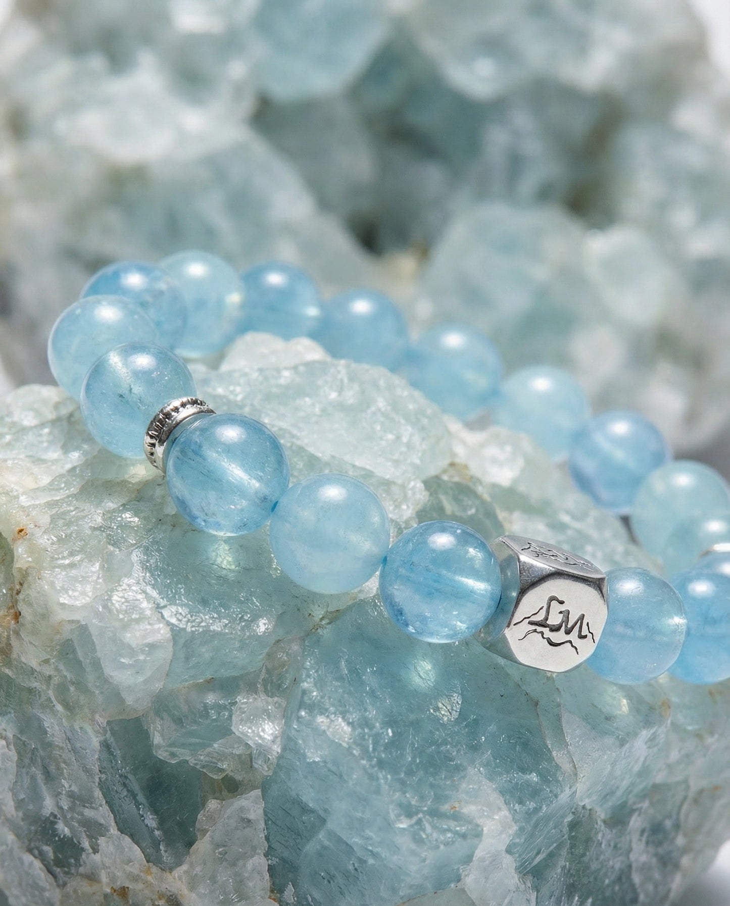 Concord water crystal bracelet — light and dark aquamarine — on raw aquamarine mineral cluster — Leymen Jewels