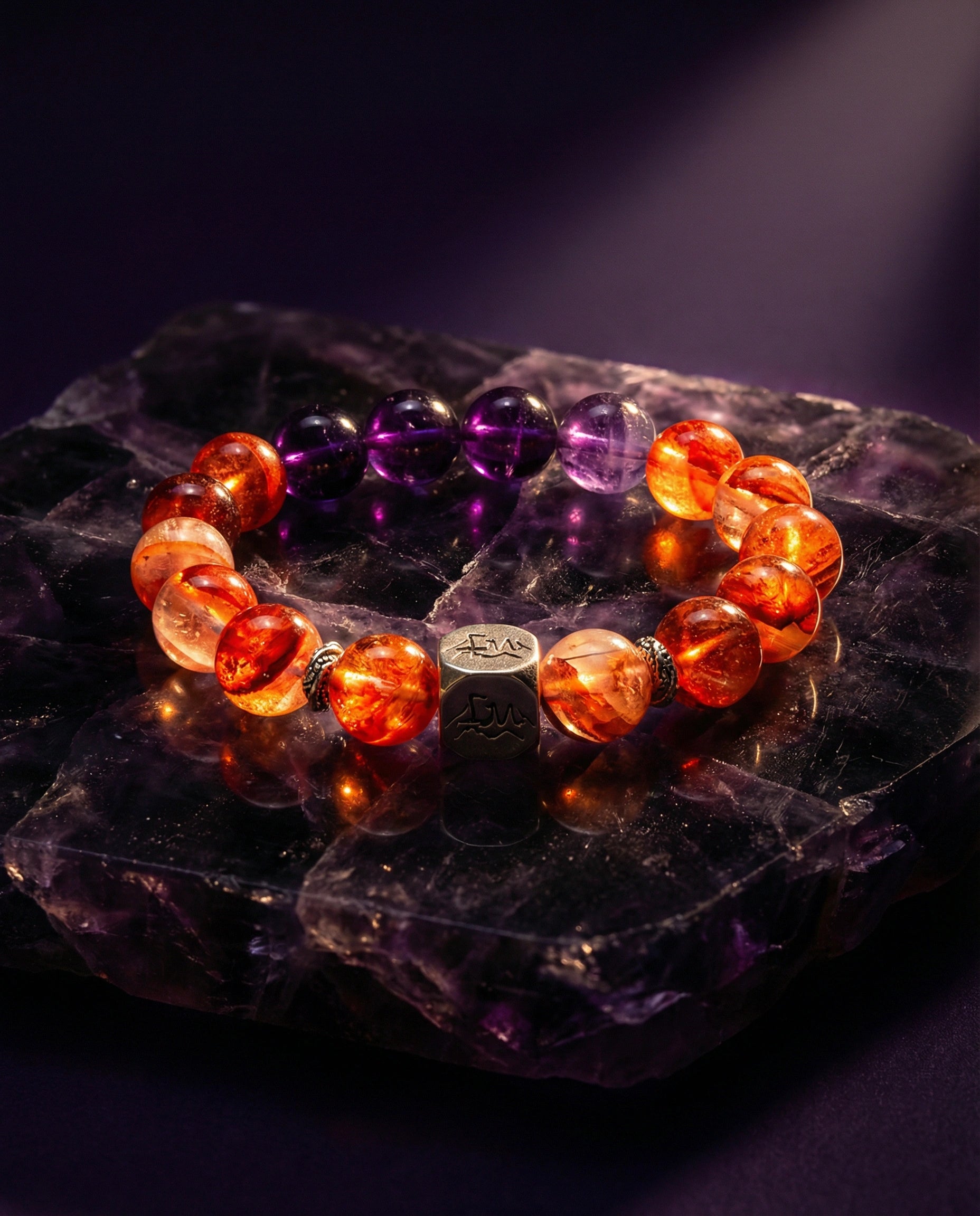 Ember fire crystal bracelet — red phantom quartz and amethyst — on dark amethyst mineral — Leymen Jewels