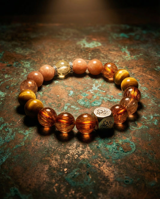 Ironflare earth crystal bracelet — copper rutilated quartz and sunstone — on aged copper surface — Leymen Jewels