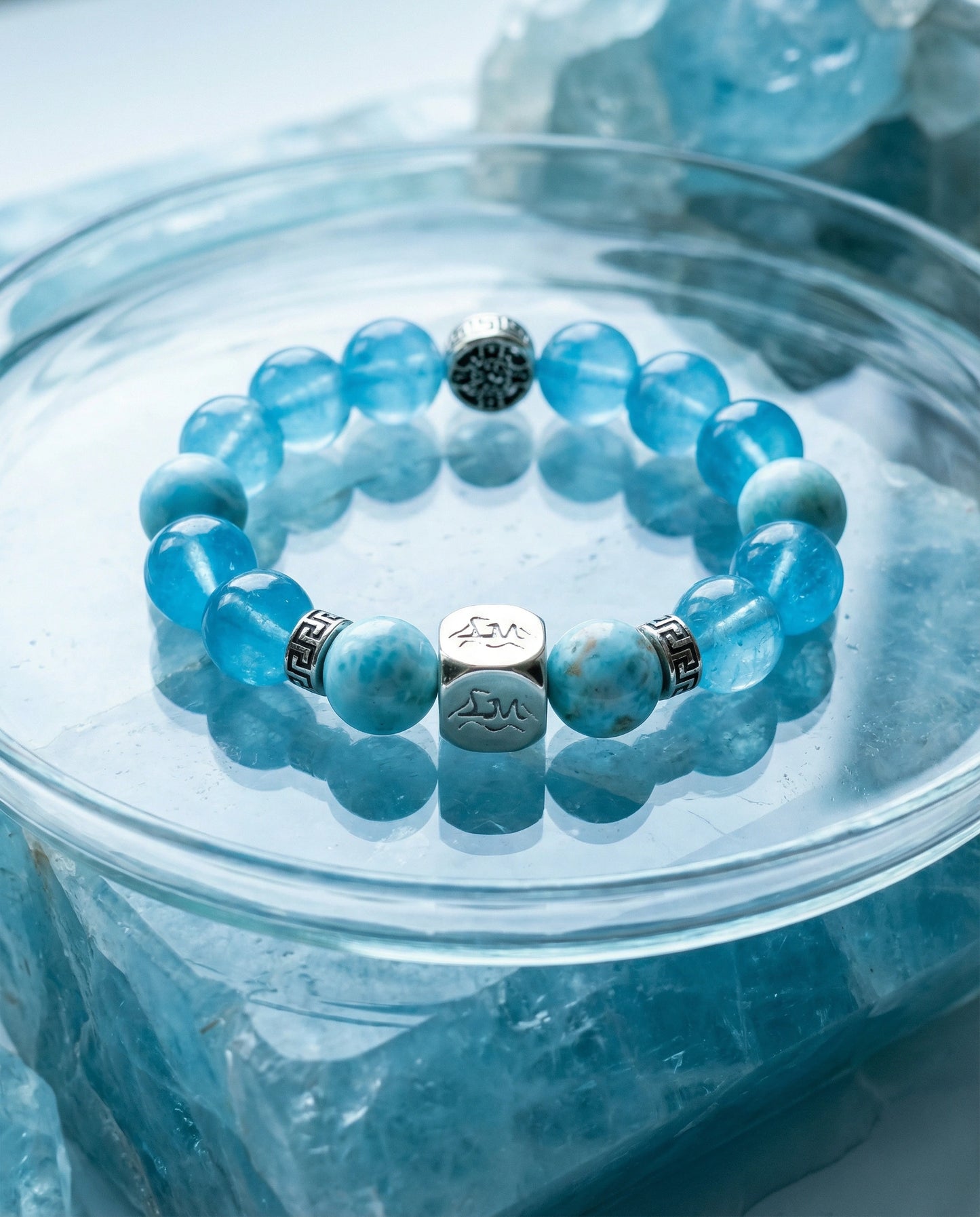 Mariner water crystal bracelet — larimar and dark aquamarine — in glass bowl on raw aquamarine crystals — Leymen Jewels