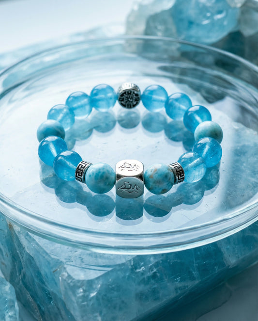 Mariner water crystal bracelet — larimar and dark aquamarine — in glass bowl on raw aquamarine crystals — Leymen Jewels