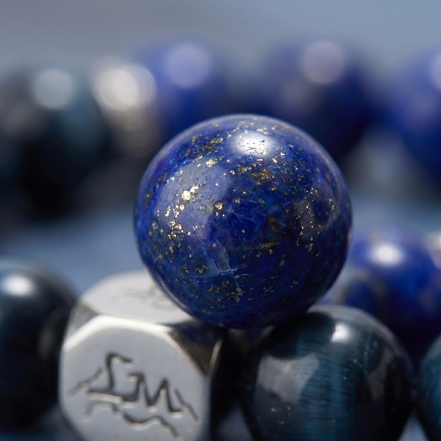 Oracle water crystal bracelet — lapis lazuli macro detail showing deep blue stone with gold pyrite flecks — Leymen Jewels