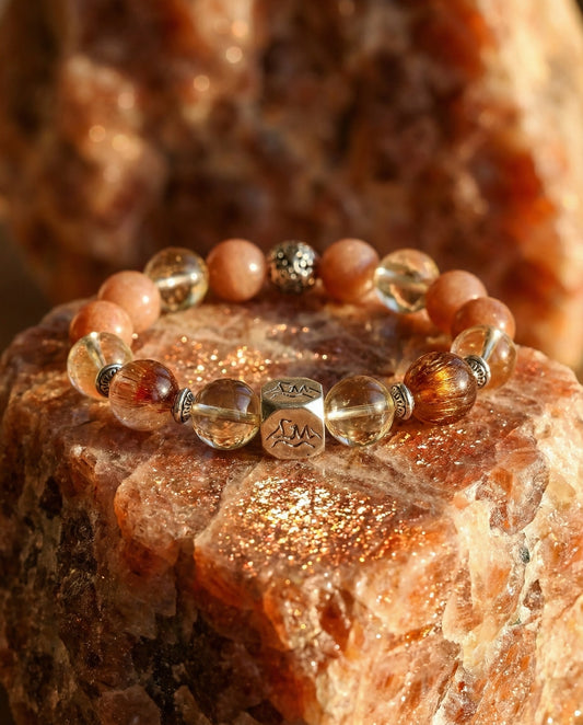 Radiance earth crystal bracelet — citrine, sunstone, copper rutilated quartz — on raw sunstone mineral — Leymen Jewels
