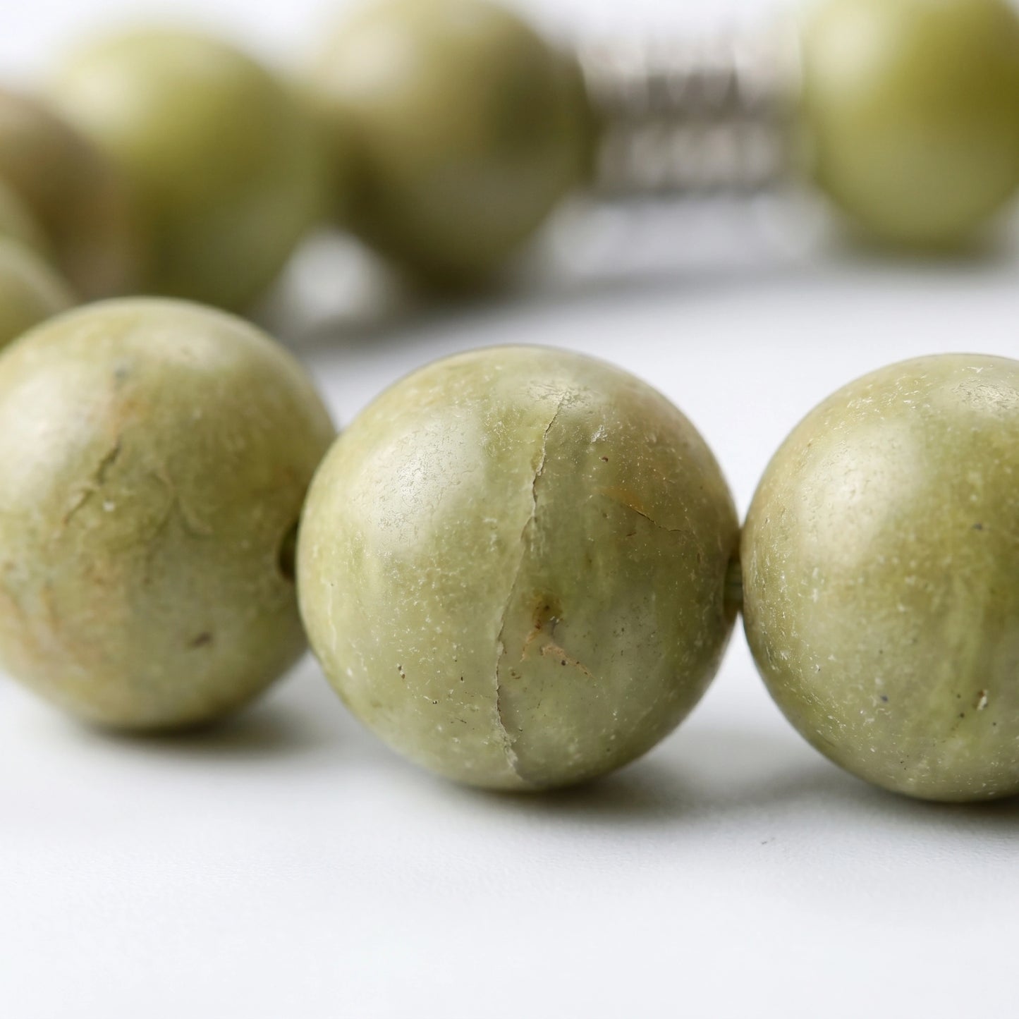 Sentinel earth crystal bracelet — blue pyrophyllite macro detail showing natural matte olive-green texture — Leymen Jewels