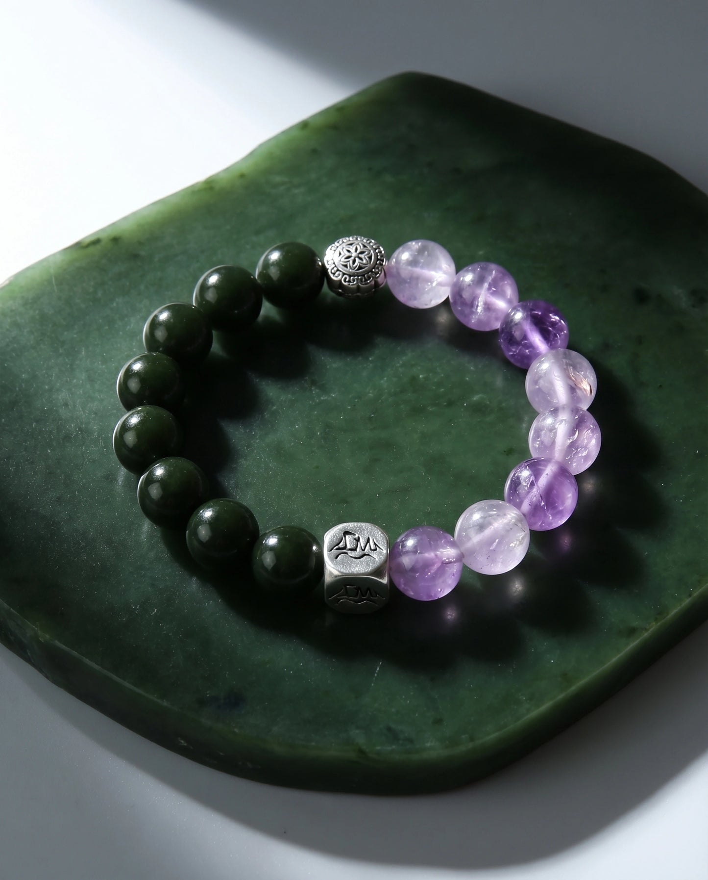 Seren wood crystal bracelet — nephrite jade and lavender amethyst — on polished nephrite jade dish — Leymen Jewels