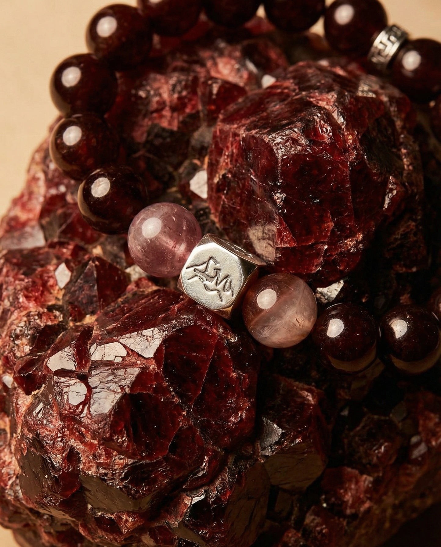 Solaris fire crystal bracelet — orange garnet and purple auralite-23 — on raw garnet mineral cluster — Leymen Jewels