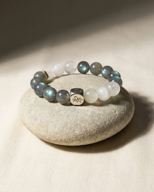 Threshold metal crystal bracelet — grey moonstone snow quartz and garnierite — on smooth river stone and linen — Leymen Jewels