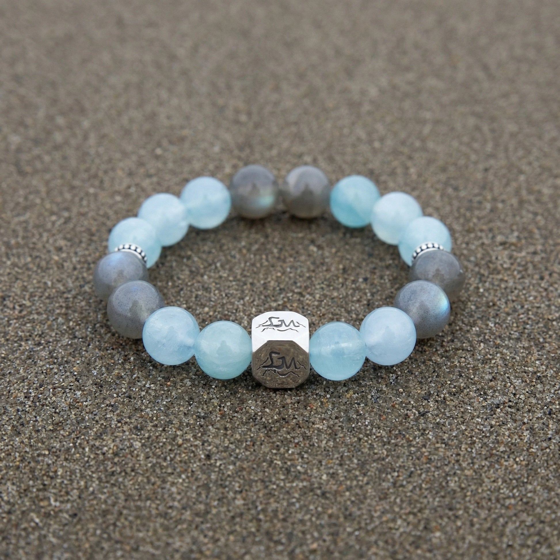 Tide water crystal bracelet — light aquamarine and grey moonstone — on wet ocean sand — Leymen Jewels