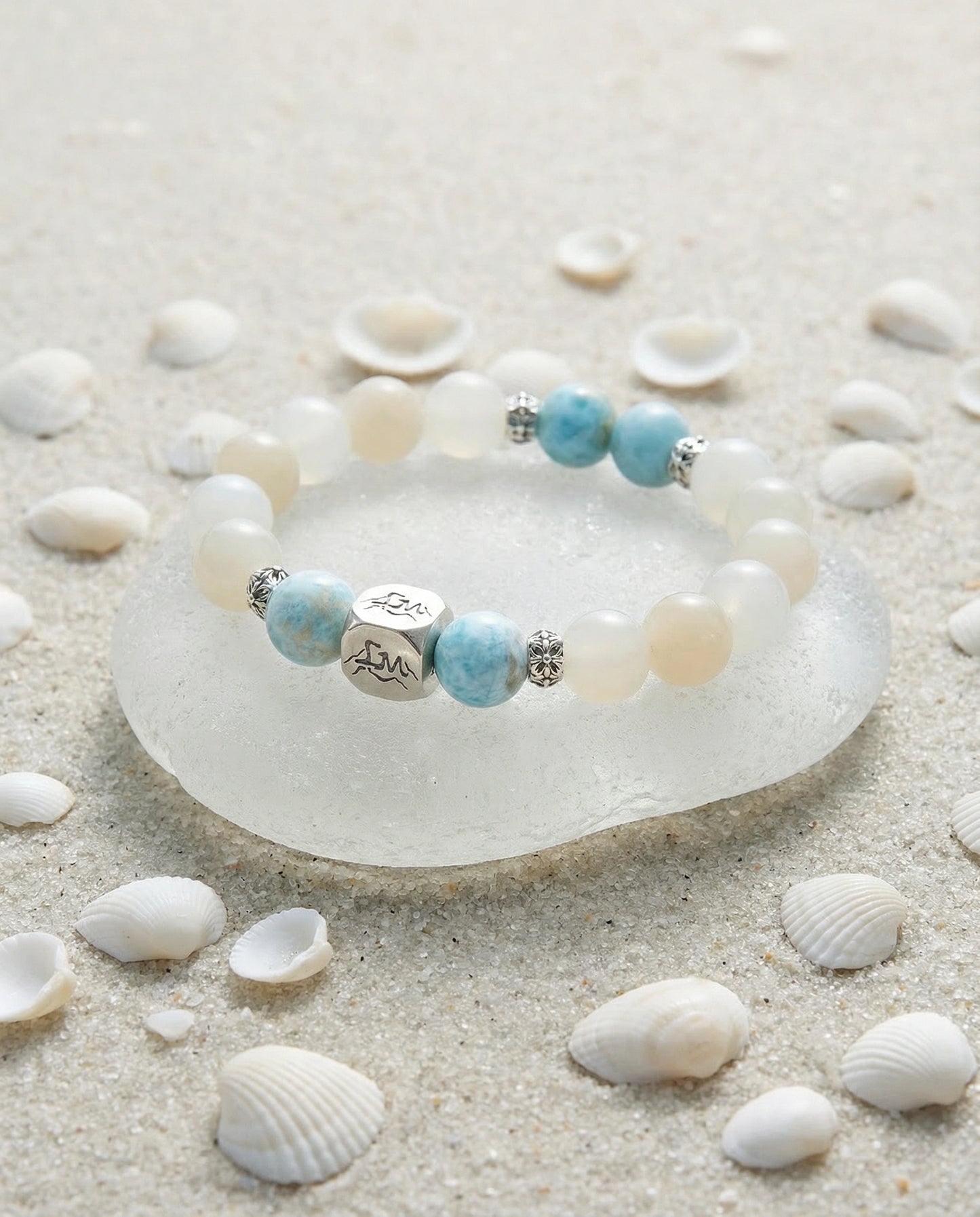 Tideborne water crystal bracelet — larimar and garnierite — on sea glass with white sand and shells — Leymen Jewels