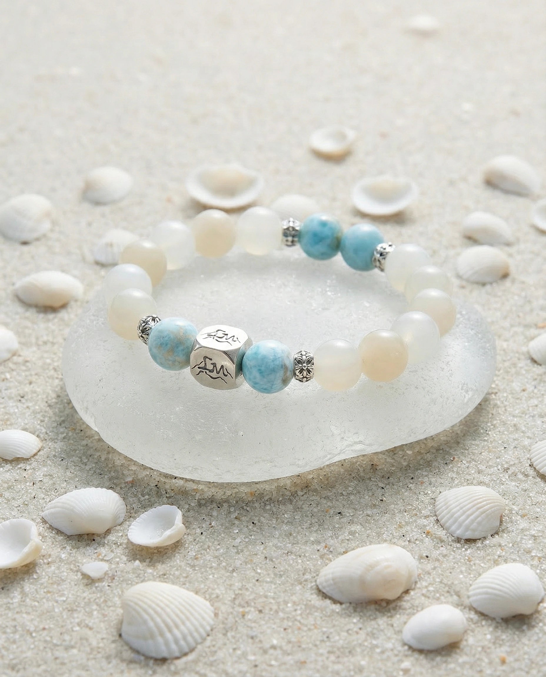 Tideborne water crystal bracelet — larimar and garnierite — on sea glass with white sand and shells — Leymen Jewels